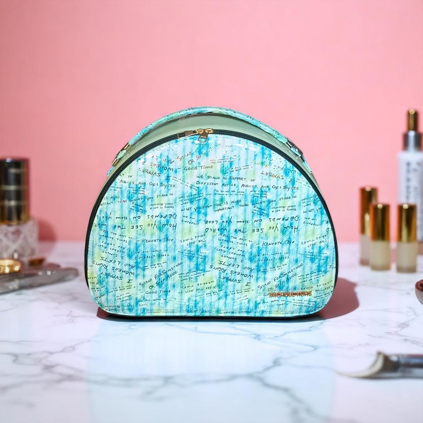 Cosmetic bag with blue and green pattern on a marble surface with pink background