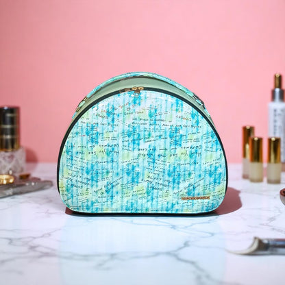 Cosmetic bag with blue and green pattern on a marble surface with pink background